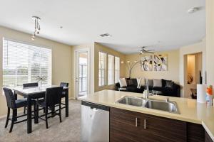 a kitchen and living room with a sink and a table at Luxury 2BR/2BA! 5 MIN to Disney! in Anaheim