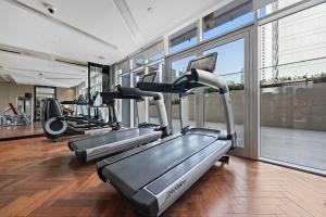 a gym with treadmills and elliptical machines at Luxe 1BR sleeps 4, Near Burj Khalifa and Dubai Mall with Pool and free Parking in Dubai