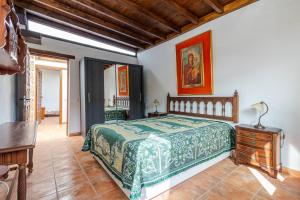 a bedroom with a bed and a table in a room at Flatguest Amiga Mia - Traditional House in Las Palmas de Gran Canaria