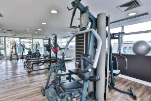 a gym with several tread machines in a building at Radisson Berrini Suite executiva Luxo Queen in São Paulo