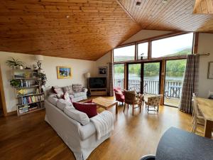 a living room with a couch and a table at Ptarmigan Lodge in Pitlochry