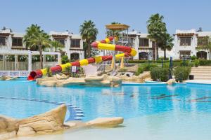 a water slide in a swimming pool in a resort at Amphoras Aqua Adults Friendly in Sharm El Sheikh