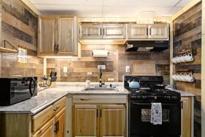 a kitchen with wooden cabinets and a stove top oven at Leadville Motor Lodge in Leadville