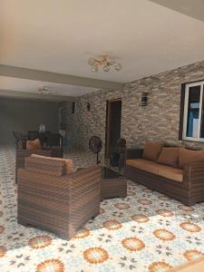 a living room with two couches and a brick wall at Lujoso vacacional en Pedro Brand in Pedro Brand