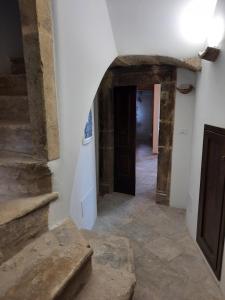 a hallway in a house with a door and stairs at Il sogno in Santo Stefano di Sessanio