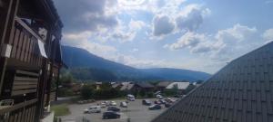 a view of a parking lot with mountains in the background at Studio Samoëns Septimontain 2/4 pers in Samoëns