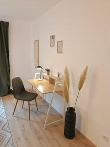 a desk and a chair in a room at Bright and central with 2 beds incl workspace in Bochum