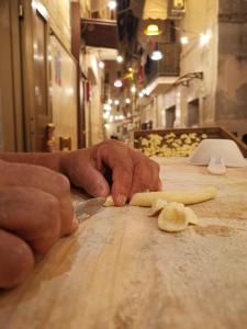 una persona cortando un trozo de comida en una mesa en La Casa di Nunzia, en Bari