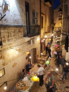 an overhead view of a group of people preparing food in an alley at La Casa delle Tradizioni in Bari