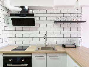 a kitchen with a sink and white tiled wall at Benidorm beach, playa de Benidorm in Benidorm