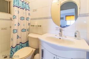 a bathroom with a sink and a toilet and a mirror at Espacioso y Cómodo Dpto. Bien Iluminado en Mty in Monterrey