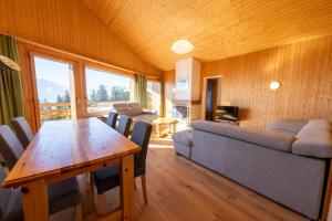 a living room with a table and a couch at Eden Resort Anzère in Anzère