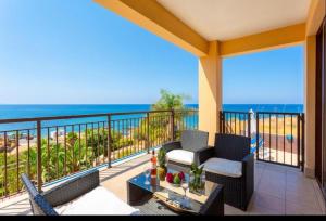 a balcony with a view of the ocean at Mermaid Villa in Pomos