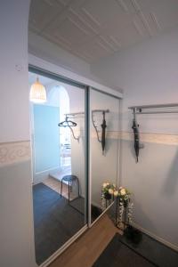 een kamer met een spiegel en een paar geweien aan de muur bij Atmospheric hundred-year-old stone house apartment near Aurajoki in Turku