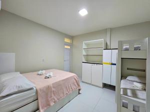 a bedroom with a bed with two stuffed animals on it at MANERO POUSADA e HOSTEL in Natal