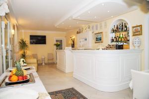 a large kitchen with a bar in a room at Falli Exclusive Rooms and Breakfast -Boutique B&B- in Porto Cesareo