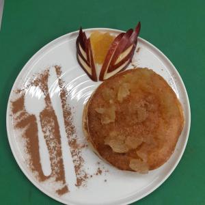 a plate of food with a fork and a piece of fruit at Despoina's Apartment in Vátos