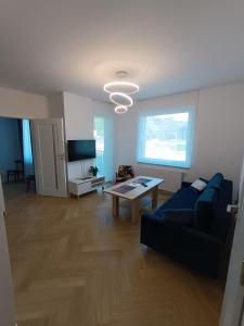 ein Wohnzimmer mit einem Sofa und einem Tisch in der Unterkunft Apartament Kopernika in Nowe Miasto Lubawskie
