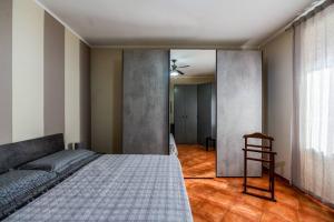 a bedroom with a bed and a chair in it at Moderno appartamento a due passi dai Navigli in Rozzano