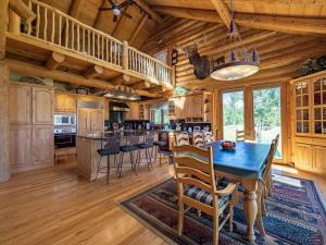 a dining room and kitchen with a table and chairs at Sun Valley Cabin in Grand Lake