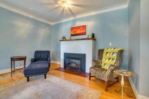 a living room with two chairs and a fireplace at Historic Seattle Vacation Rental in Seward Park! in Seattle