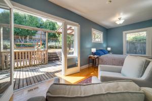 a living room with a couch and a sliding glass door at Historic Seattle Vacation Rental in Seward Park! in Seattle
