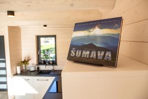 a book sitting on top of a counter in a kitchen at Chalet Belveder Železná Ruda in Železná Ruda