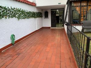 a brick walkway in front of a white building at Hostal Luxury Bogota in Bogotá