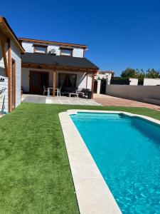 a swimming pool in front of a house at Luxury Rural Cuenca in Cuenca
