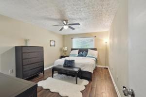 a bedroom with a bed and a ceiling fan at Convenient Athens Condo with Patio about 3 Mi to UGA! in Athens