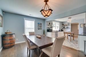 a kitchen and dining room with a wooden table and chairs at Charming Knoxville Home 2 Mi to Neyland Stadium! in Knoxville