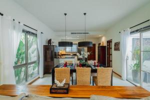 a kitchen and dining room with a table and chairs at Ivory Pool Villa in Nai Harn in Rawai Beach