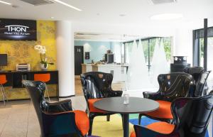 a waiting room with a table and chairs at Thon Hotel Vika Atrium in Oslo