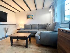 a living room with a couch and a coffee table at Hebaska~Watergate Bay~3 Bedroom in Porth