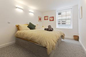 a bedroom with a bed and a window at Luxury 3-Bed Apartment - Sheffield City Centre - Netflix, WIFI, Radio, Interactive Mood Lighting, State of the Art in Sheffield