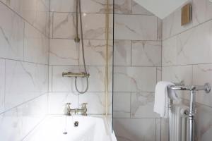 a bathroom with a shower and a sink at Bankside Cottage in Bedale