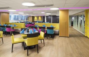 a dining room with tables and chairs and a cafeteria at Thon Hotel Vika Atrium in Oslo