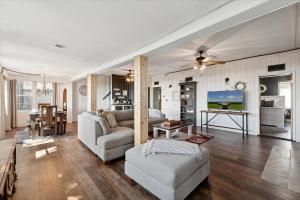 a living room with a couch and a table at Lakefront Family Home/Golf Cart/Beach in Luna Pier