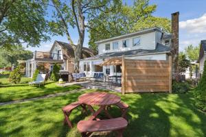 a yard with a wooden table in front of a house at Lakefront Family Home/Golf Cart/Beach in Luna Pier