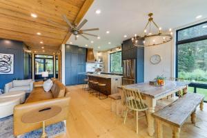 a kitchen and living room with a wooden ceiling at Modern Turnerville Cabin with Hot Tub and Scenic Views in Thayne