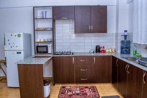 een keuken met houten kasten en een aanrecht bij Penthouse in Eldoret