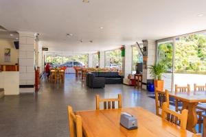 a restaurant with tables and chairs and a room with tables and chairs at Hotel Verony Guatape in Guatapé