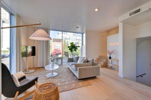 a living room with a couch and a chair at Rooftop with Views Modern Little Italy Townhome in San Diego