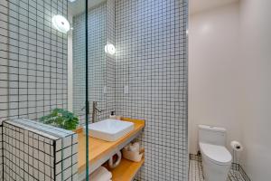 a bathroom with a sink and a toilet in it at Rooftop with Views Modern Little Italy Townhome in San Diego +25 photos