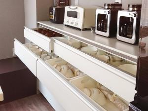a kitchen with white drawers and appliances at KAMUY RERA - Vacation STAY 62288v in Kushiro