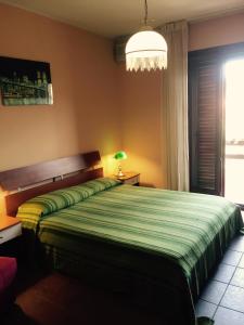 A bed or beds in a room at La ginestra Chia B&B