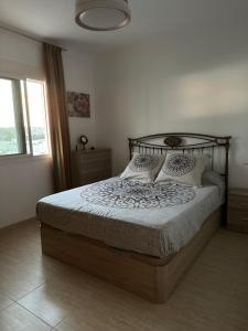 a bedroom with a bed with a metal headboard and pillows at Costa Dorada in Fuengirola