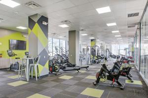 a gym with treadmills and exercise bikes in it at Awesome 2bedroom With Pool, Gym & Parking I Ave in Philadelphia