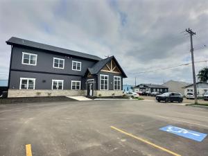 a black house with a parking lot in front of it at Summer Suite - Pet Friendly in Brandon