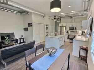 a large kitchen and living room with a table and chairs at Summer Suite - Pet Friendly in Brandon
